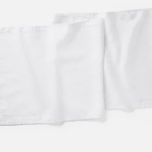 Coyuchi Olivos Embroidered Linen table runner in white, pair shown flat.