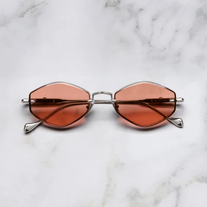 An image of the Cutler and Gross The Great Frog Carol Rectangular Sunglasses in gun metal/gold frame frontal view with arms closed marble background