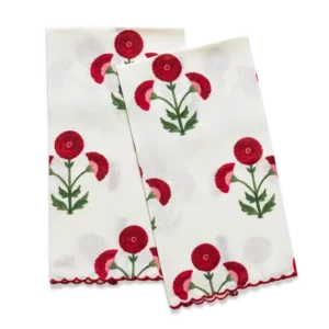 Matouk Gisele ivory linen guest towels with red floral print and scalloped edges.