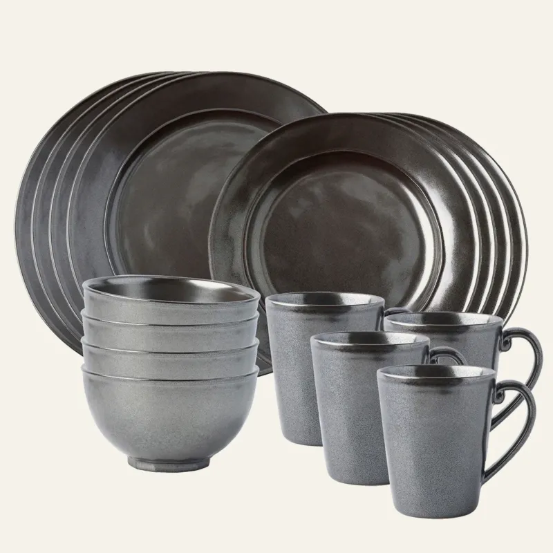 Juliska Pewter stoneware 16-piece place setting with plates, bowls, and mugs.