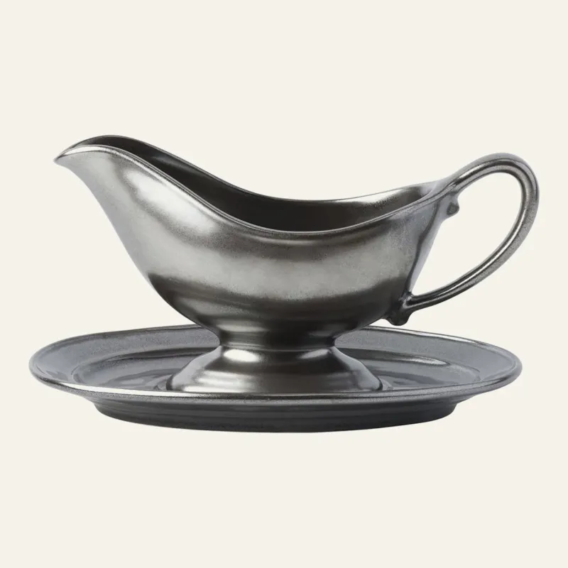 Juliska pewter stoneware sauce boat and stand set with metallic finish.