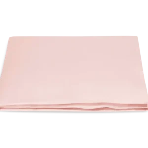 Matouk Marcella fitted sheet in blush, folded neatly against a white background.