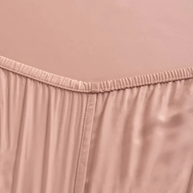 Close-up of the Cuddle Pink bamboo fitted sheet's elasticated corner seam.