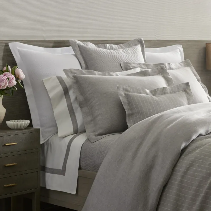 Home Treasures Chester quilted coverlet and euro shams in silver and ivory on styled bed.