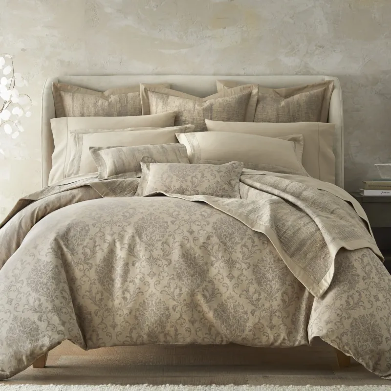 Home Treasures Eloise quilted coverlet in champagne damask jacquard on styled bed.