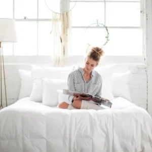 Ogallala Comfort Mariposa Lightweight Hypodown Comforter in white, styled on bed.